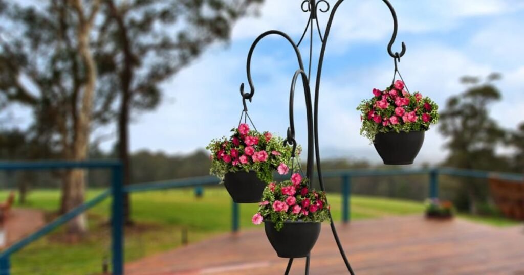 Outdoor plant hanger stand with multiple pots on a small balcony